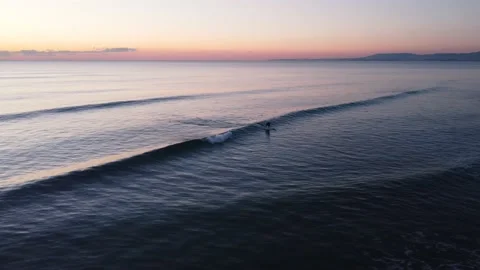 Surfer catching Waves during Sunset in Costa da Caparica beach, Portugal Stock Footage 146102517
