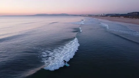 Surfer catching Waves during Sunset in Costa da Caparica beach, Portugal Stock Footage 146102598