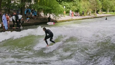 Surfer in the city river called Eisbach at Munich, Germany Stock Footage 281319221