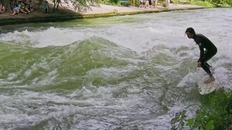 Surfer in the city river called Eisbach at Munich, Germany Stock Footage 282274474
