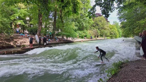 Surfer in the city river called Eisbach at Munich, Germany Stock Footage 282275232