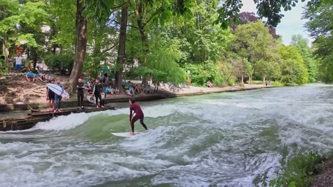 Surfer in the city river called Eisbach at Munich, Germany Stock Footage 282275250