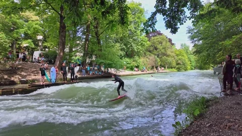 Surfer in the city river called Eisbach at Munich, Germany Stock Footage 282275604