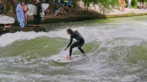 Surfer in the city river called Eisbach at Munich, Germany Stock Footage 284032358
