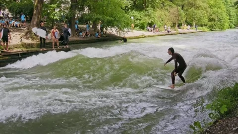 Surfer in the city river called Eisbach at Munich, Germany Stock Footage 284032399