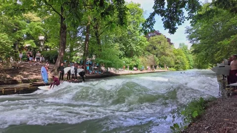 Surfer in the city river called Eisbach at Munich, Germany Stock Footage 287469304