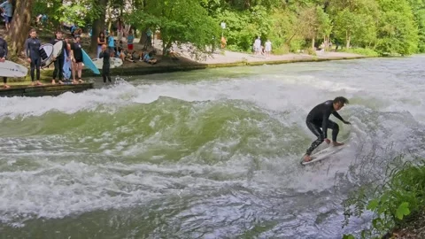 Surfer in the city river called Eisbach at Munich, Germany Stock Footage 295636634