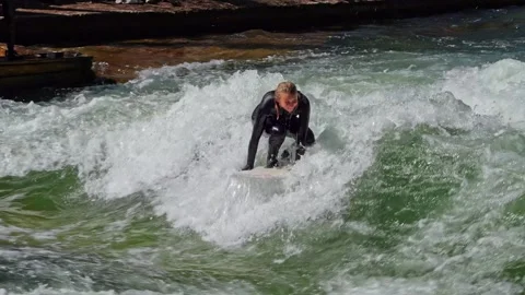 Surfer in the city river called Eisbach at Munich, Germany Stock Footage 307314946