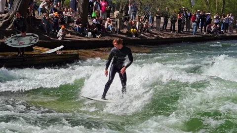 Surfer in the city river called Eisbach at Munich, Germany Stock Footage 307315034