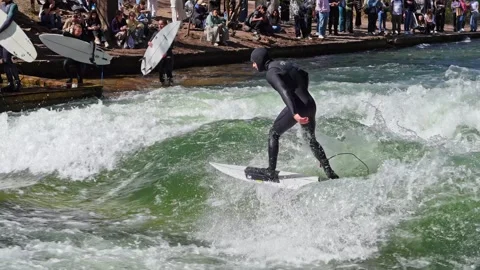 Surfer in the city river called Eisbach at Munich, Germany Stock Footage 309882653