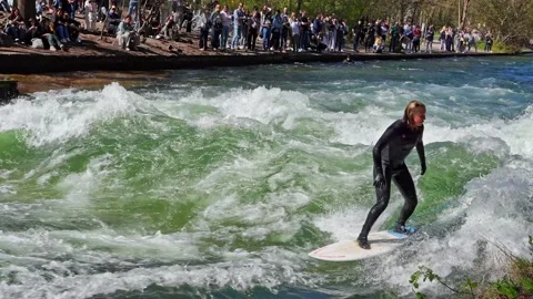 Surfer in the city river called Eisbach at Munich, Germany Stock Footage 309882667