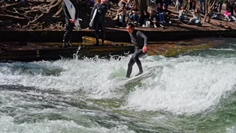 Surfer in the city river called Eisbach at Munich, Germany Stock Footage 309882712