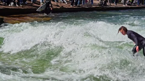 Surfer in the city river called Eisbach at Munich, Germany Stock Footage 309882774