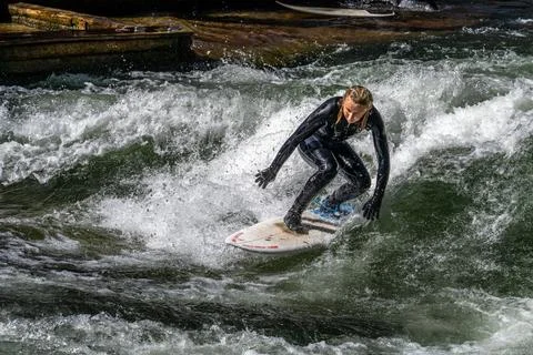 Surfer in the city river called Eisbach at Munich, Germany Stock Photos
