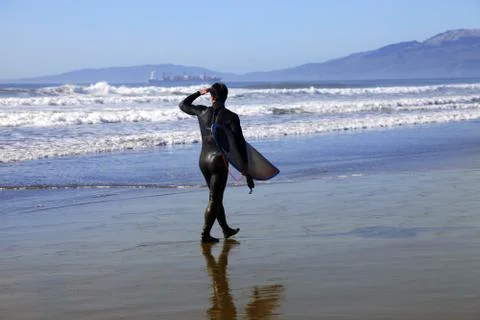 Surfer on a coastline Stock Photos