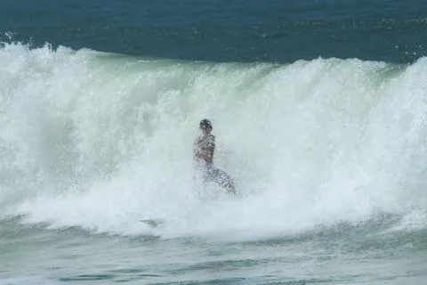 Surfer covered by wave Stock Photos