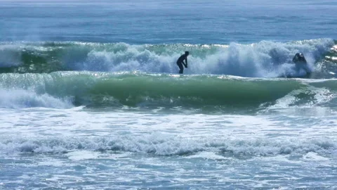 Surfer dives off surfboard Stock Footage 150980072