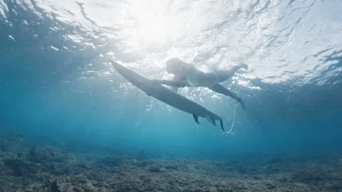 Surfer dives under the ocean wave with surfing board and passes it. Underwater Stock Footage 328129772