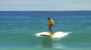 Surfer Dressed In Bright Red And Yellow Runs Out Of Wave And Spills Into The Stock Footage