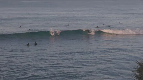 Surfer dropping in on another surfer while surfing at burleigh heads Stock Footage 279377474