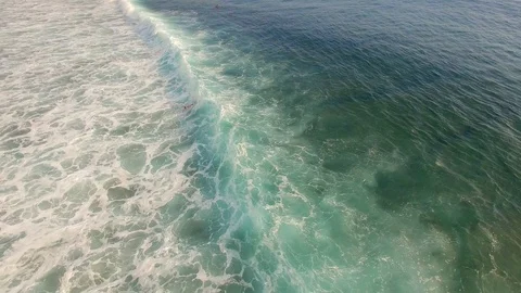 Surfer duck diving under a turquoise wave Stock Footage 98678695