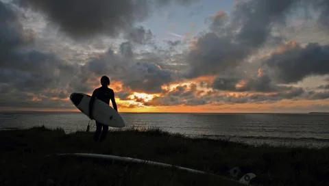 Surfer in the evening light Stock Photos