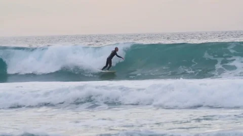 Surfer falling of his board while riding on big wave Stock Footage 71540968