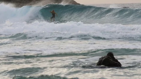 Surfer falling of his board while riding on big wave Stock Footage 71541020