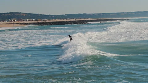 Surfer falling into the water while surfing near the Lisbon beach. Stock Footage 130626412