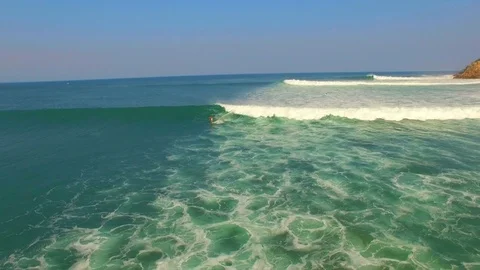 A surfer falls off a wave on the coast of Mexico. Aerial drone video. Stock Footage 72089712