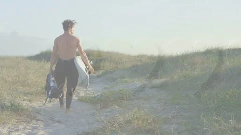 Surfer finishing surf and walking dunes holding surfboard, bag as right edge red Stock Footage 332704357