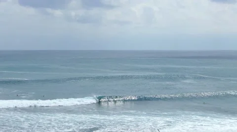 Surfer gets up on the board and rolling on the ocean 動画素材 64628027