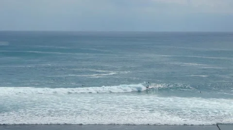 Surfer gets up on the board and rolling on the ocean 動画素材 64628036