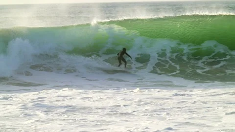 Surfer gets swallowed by the pipeline slow motion Stock Footage 146715771