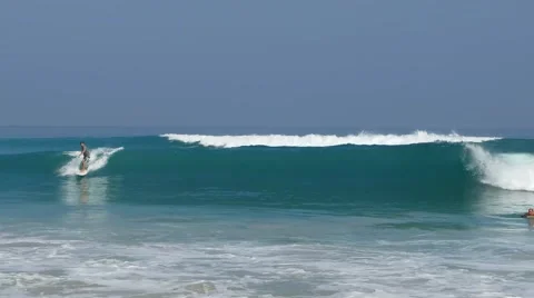 Surfer gets up on a wave 库存影片 64627993