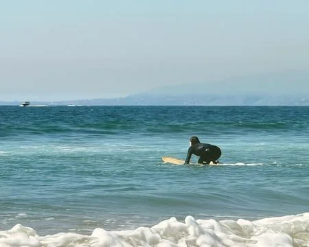 Surfer getting ready to catch a wave Stock Photos