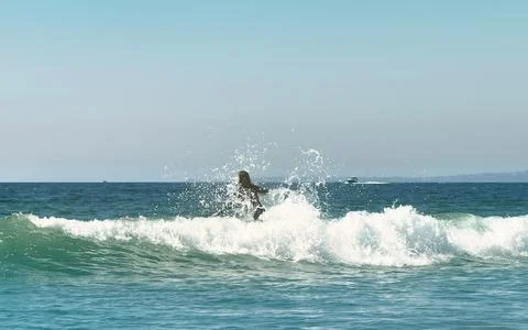 Surfer getting ready to catch a wave Stock Photos