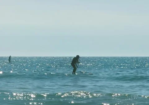 Surfer getting ready to catch a wave Stock Photos