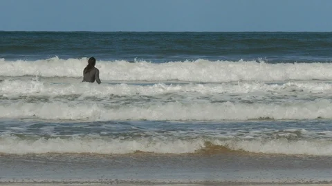Surfer getting in the water on the Atlantic ocean. Stock Footage 87721212