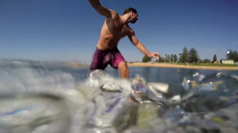 Surfer glides over a small wave in summer. Video stock 63358481