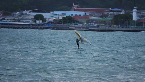 Surfer gliding over ocean waves using hydrofoil board and inflatable wing Video stock 342916337