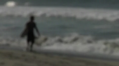 Surfer heading out Stock Footage 590559