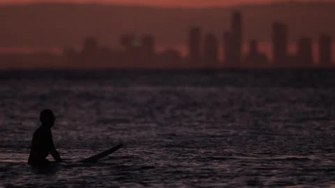 A surfer on his board at dusk Stock Footage 264147740