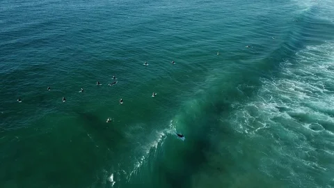 Surfer on left hander wave heading to beach from overhead Stock Footage 107072711