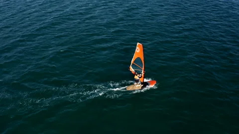 Surfer in a life jacket rides a Board with a sail Stock Footage 146245848