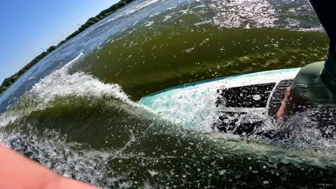 Surfer on longboard in wave behind boat making switch Stock Footage 218592377
