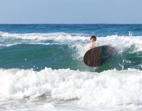 Surfer on longboard while it is falling in the waves Stock Photos