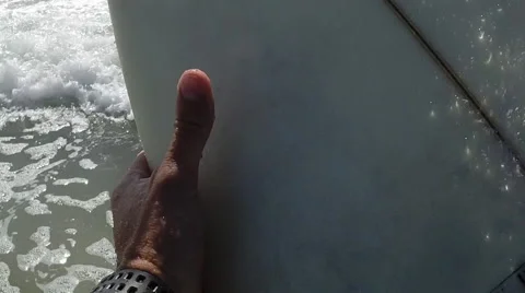 A Surfer Makes His Way Through The Tide Out To Sea. Stock Footage 50954893