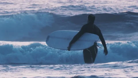 Surfer man with his surfboard going to meet the waves Stock Footage 139620330