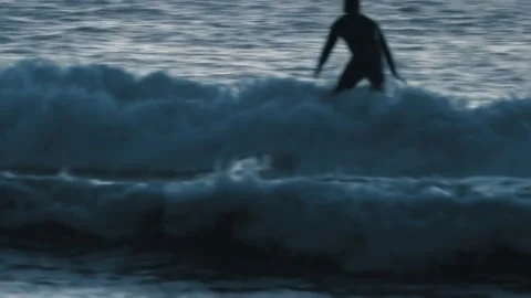 Surfer man silhouette falling on waves at sunset Video stock 139620313